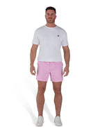 Man wearing pink shorts and white organic t-shirt.