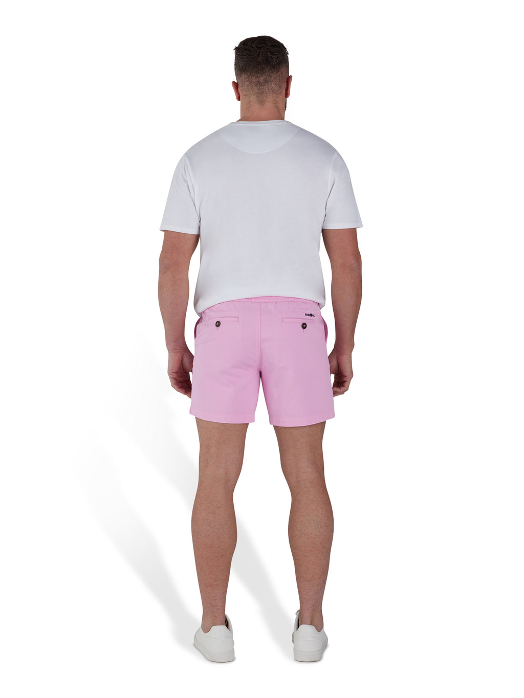 Man wearing pink shorts and a white t-shirt. 