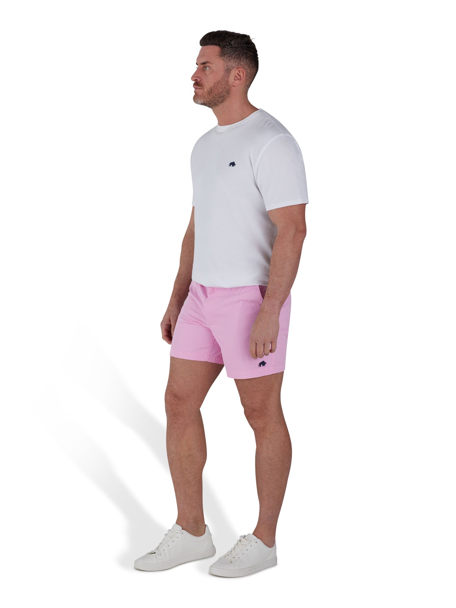 Man wearing pink shorts and a white t-shirt. 