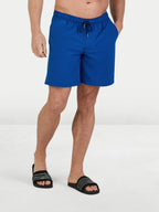 Person wearing blue shorts on a white background