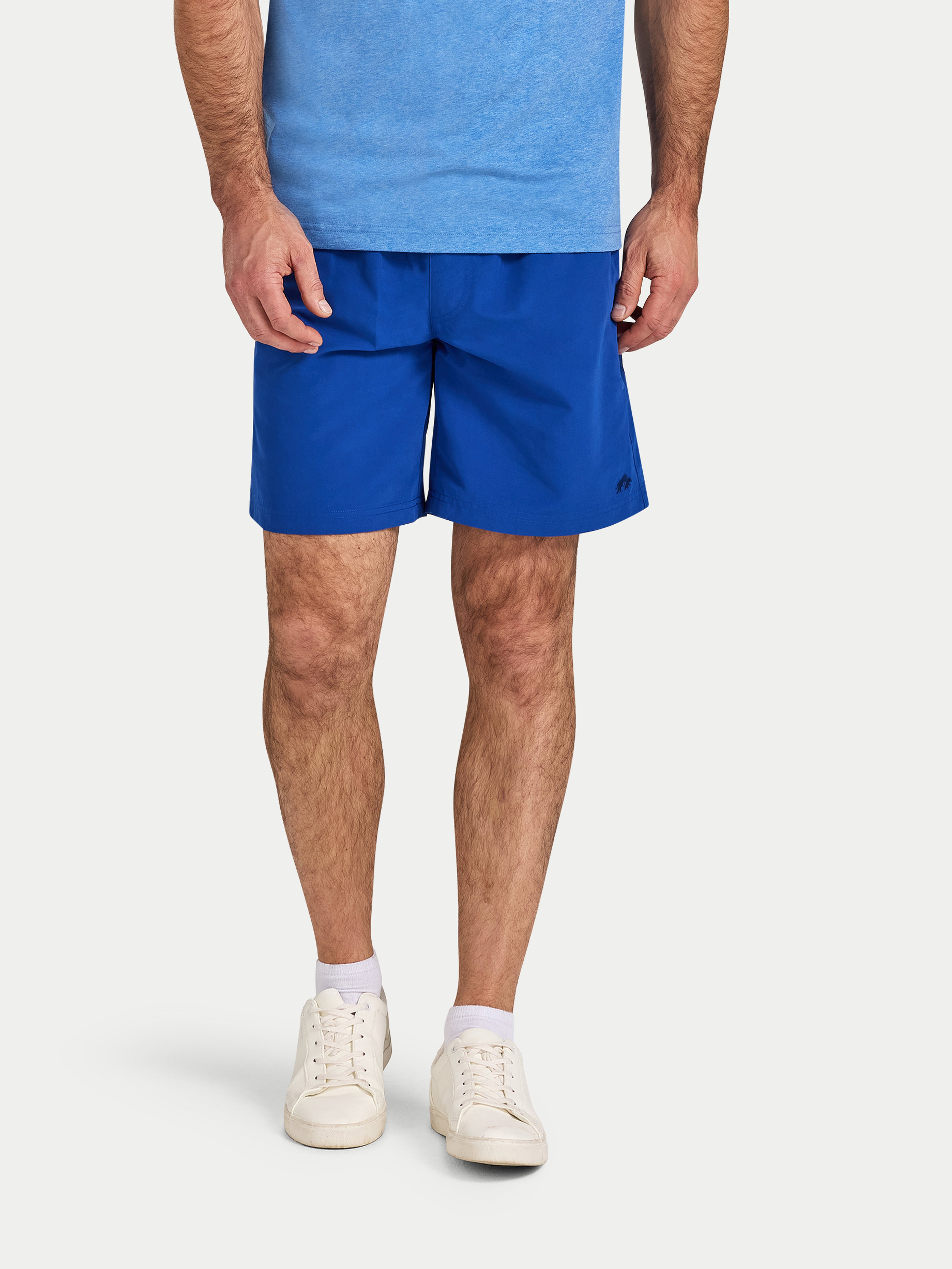 Person wearing blue shorts and a blue shirt on a white background