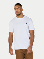 Man wearing a white t-shirt with a small logo on a plain background
