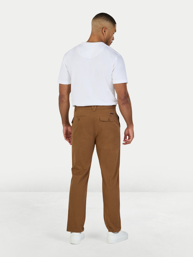 Man wearing a white t-shirt and brown pants on a white background