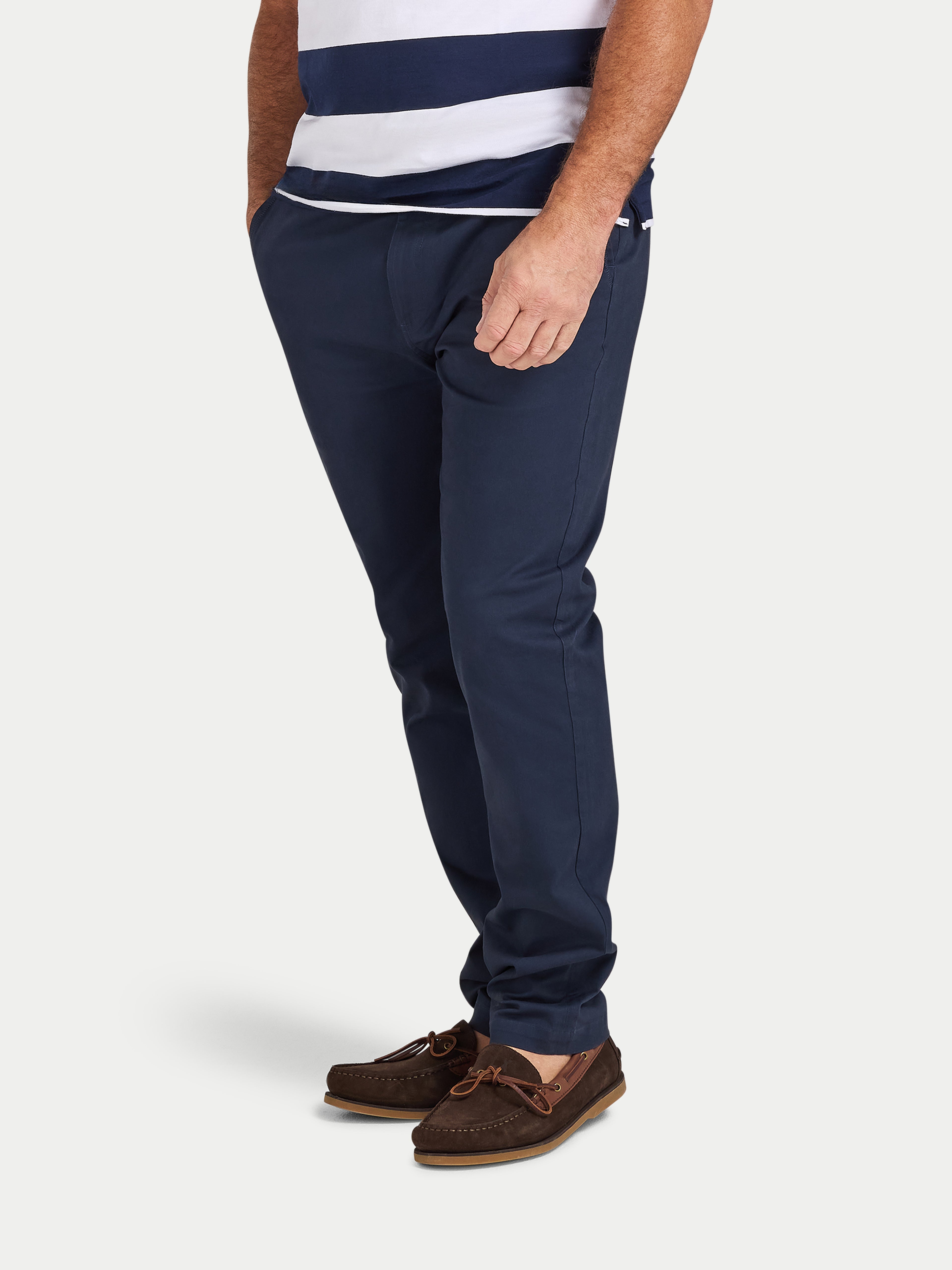 Person wearing navy pants and a striped shirt on a white background