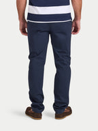 Person wearing navy pants and a striped shirt on a white background