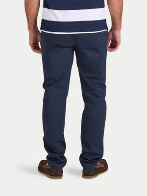 Person wearing navy pants and a striped shirt on a white background