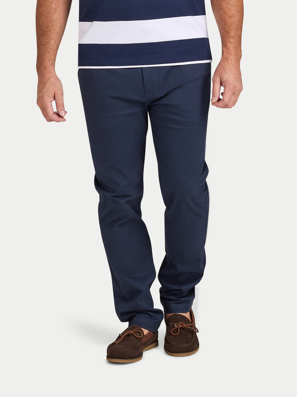 Person wearing navy pants and a striped shirt on a white background