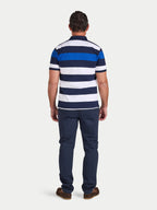 Man wearing a blue and white striped polo shirt and navy pants on a white background