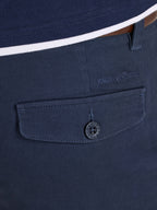 Navy blue shirt with a buttoned pocket and brand logo on a white background