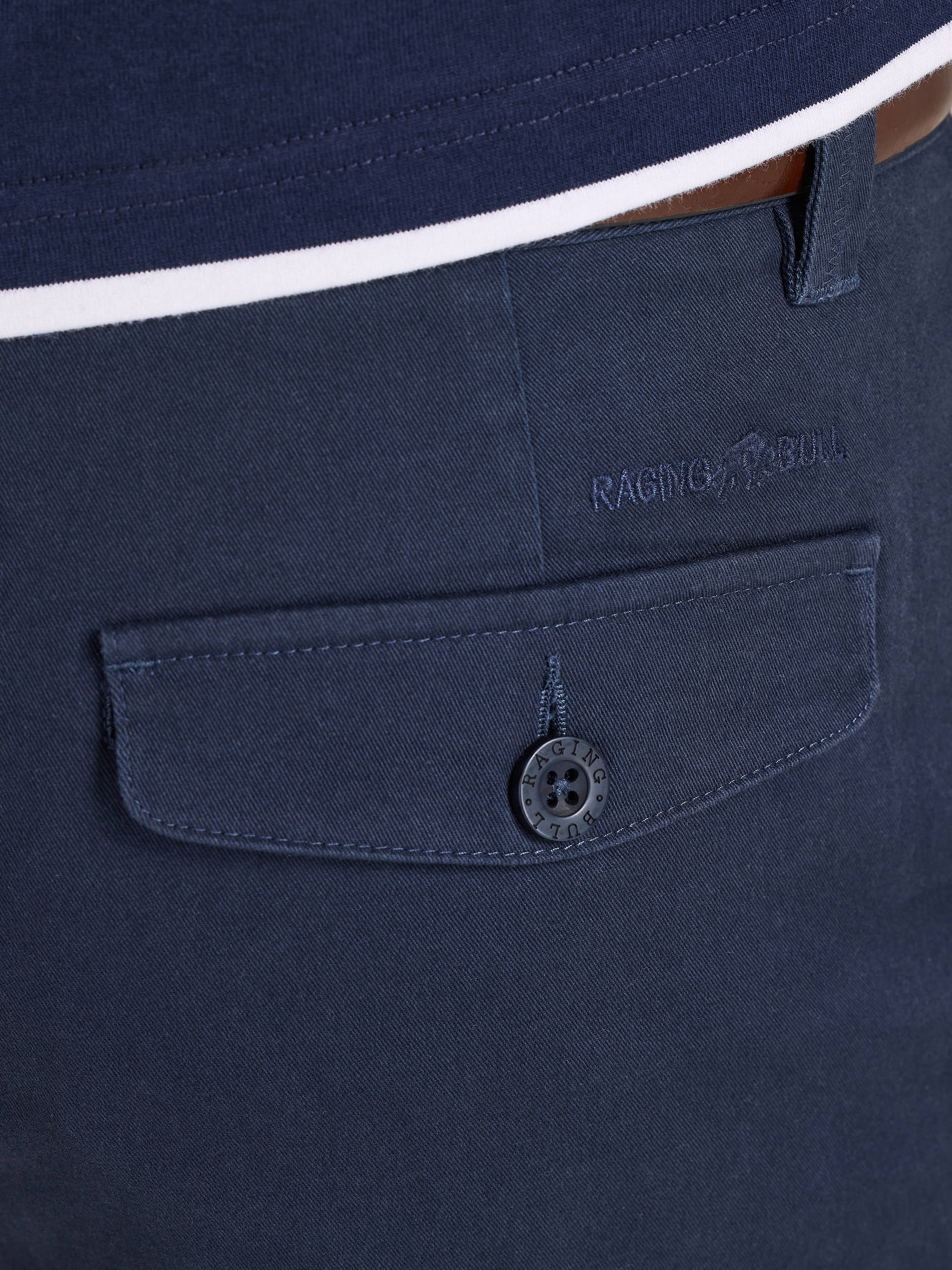 Navy blue shirt with a buttoned pocket and brand logo on a white background