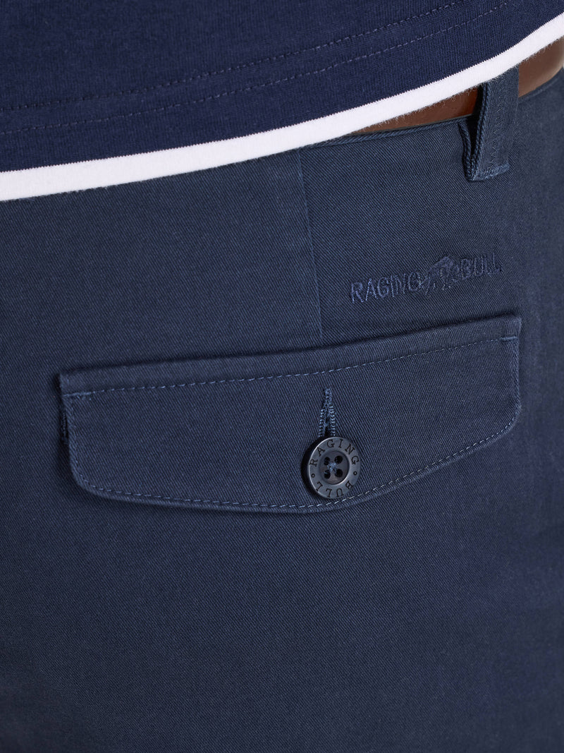 Navy blue shirt with a buttoned pocket and brand logo on a white background