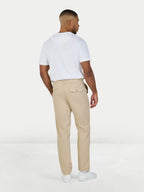 Man wearing Raging Bull Tapered Chino trousers in Tan and Classic Organic t-shirt in white, back. 
