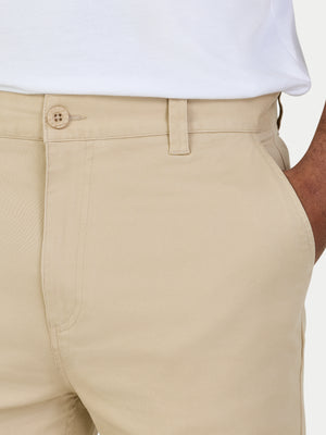 Beige pants with a white shirt worn by a person