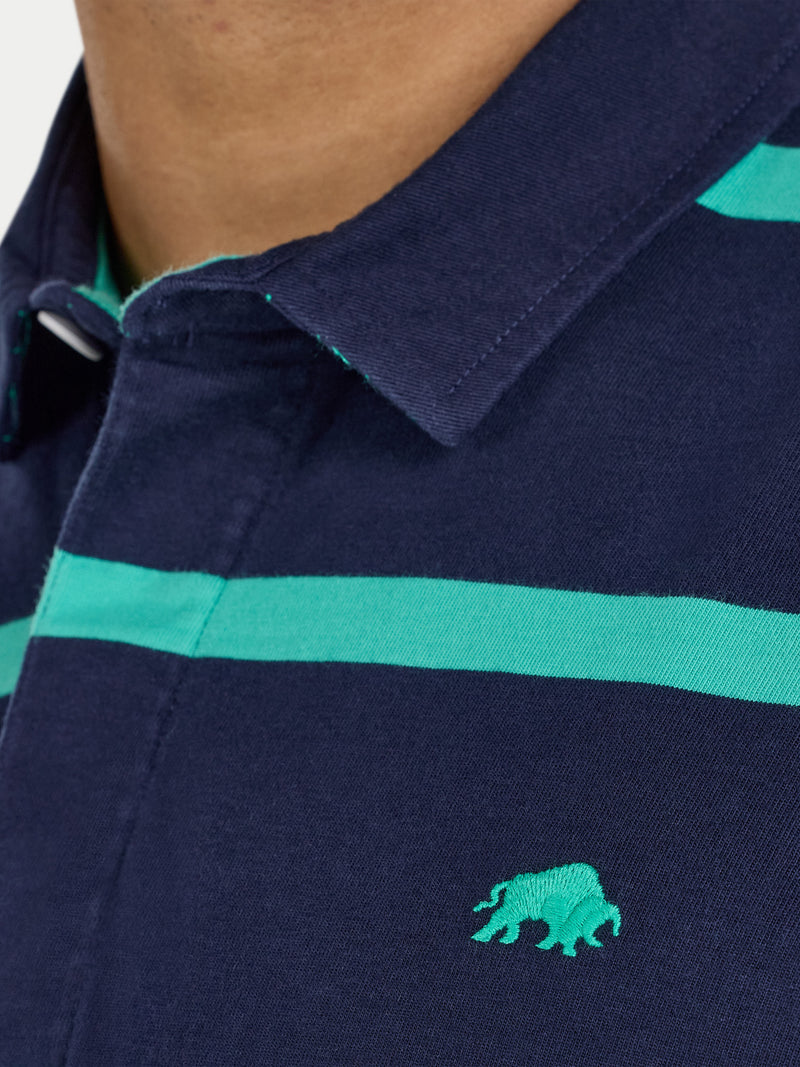 Navy blue polo shirt with green stripes and logo on a plain background