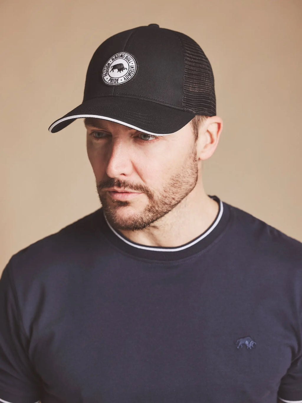 Man wearing a Raging Bull Tri colour mesh cap in black, front.
