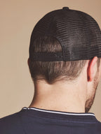 Person wearing a Raging Bull Tri colour back cap in Black, back detail.