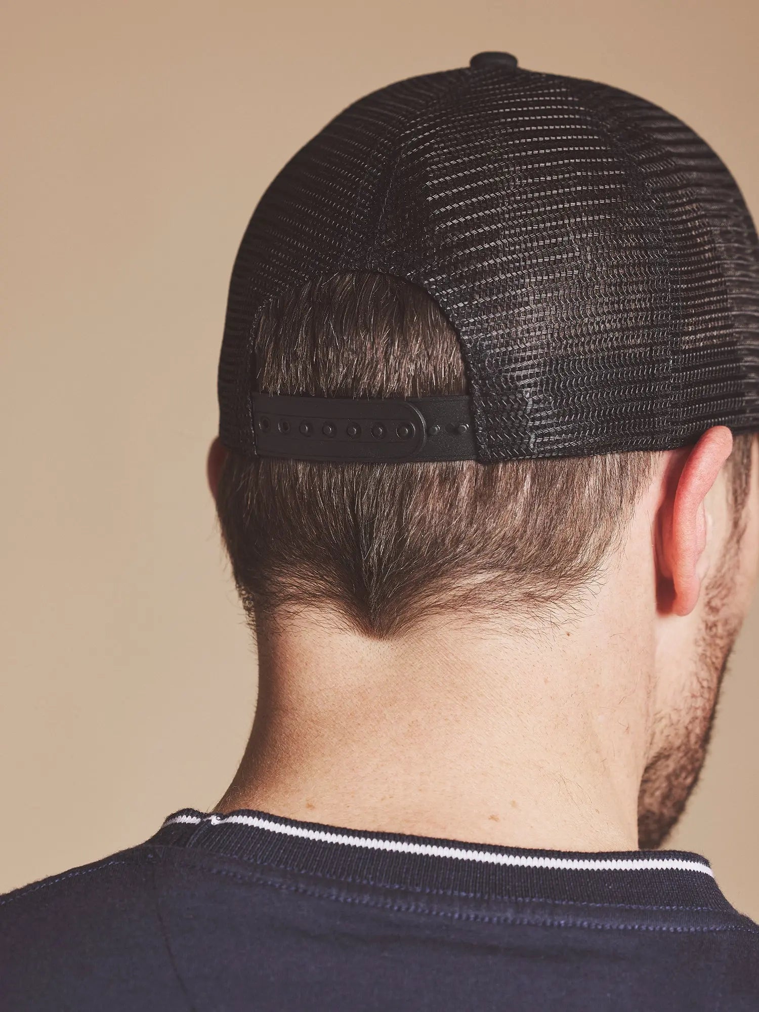Person wearing a Raging Bull Tri colour back cap in Black, back detail.