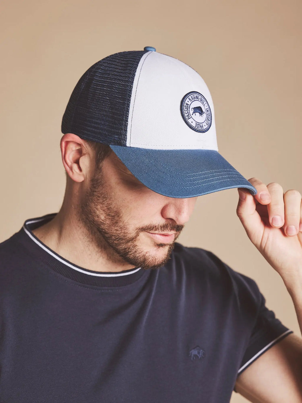 Man wearing a Raging Bull Tri Colour mesh back cap in Mid Blue, font. 