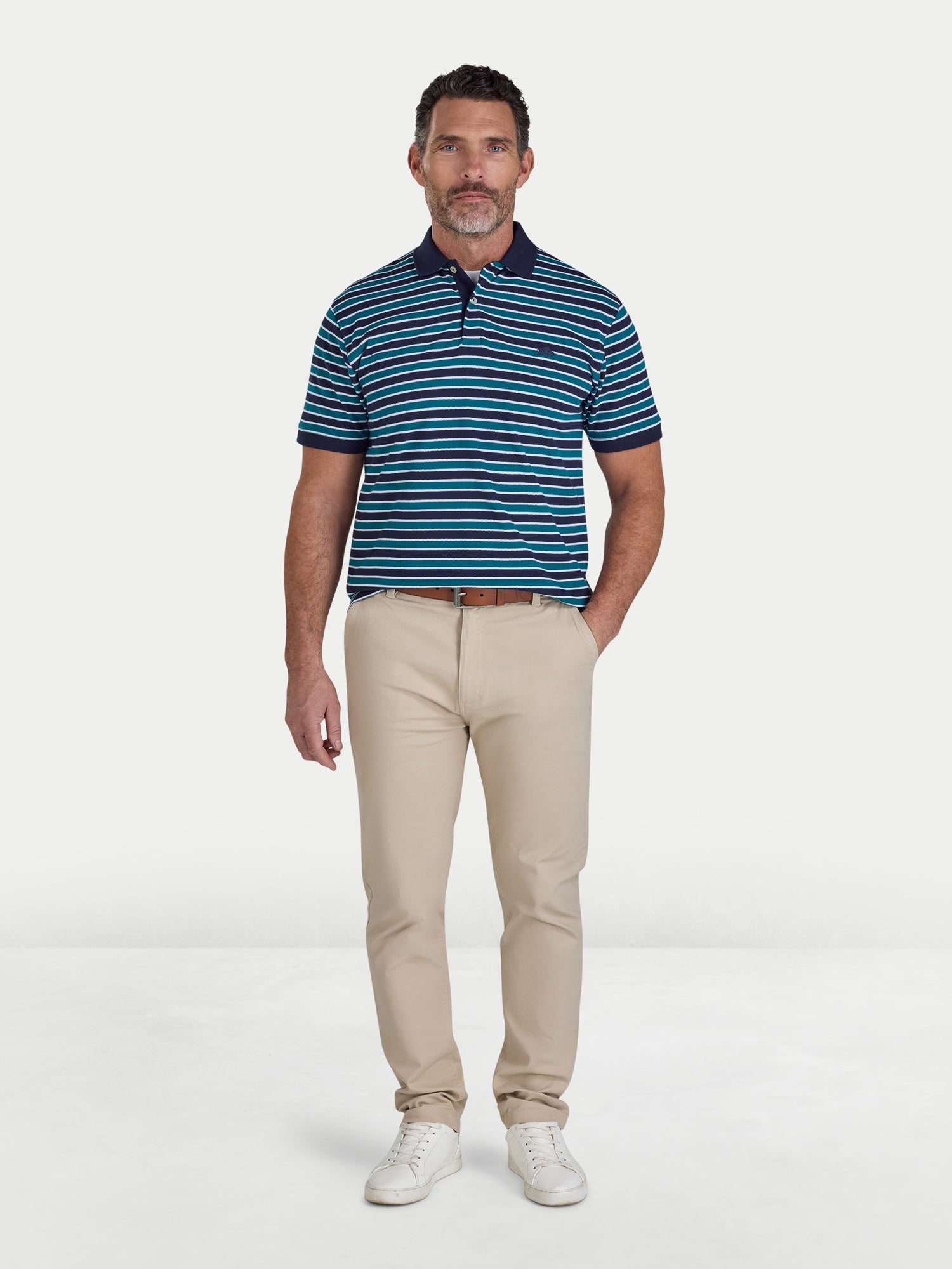 Man wearing a blue striped polo shirt and beige pants on a white background