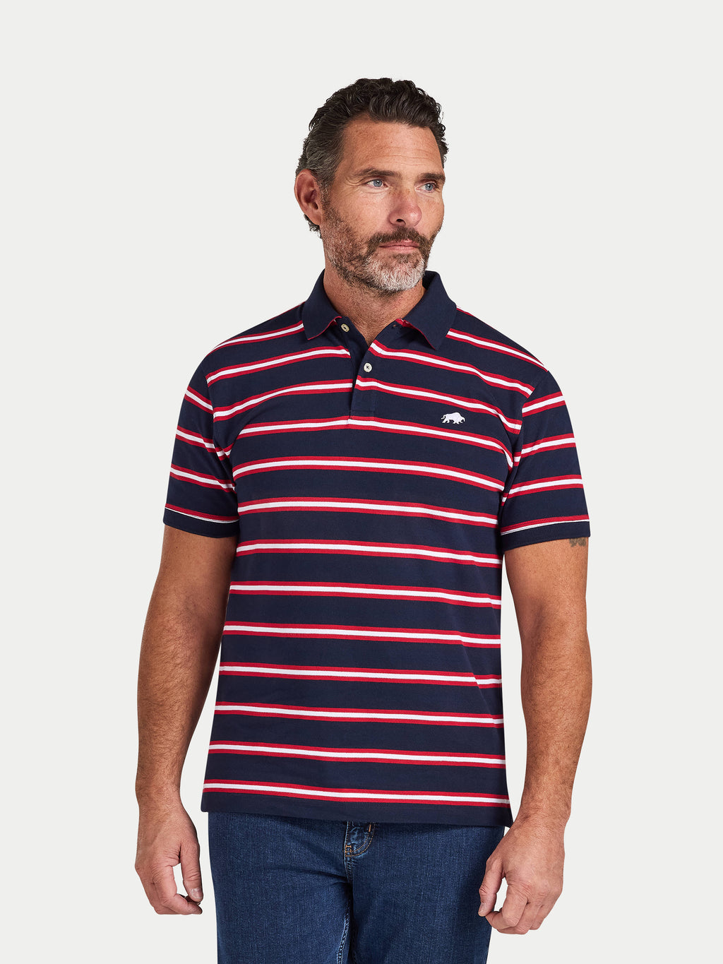 Man wearing a navy and red striped polo shirt on a light gray background