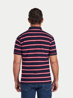Man wearing a navy and red striped polo shirt on a white background