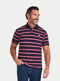 Man wearing a navy and red striped polo shirt on a light gray background