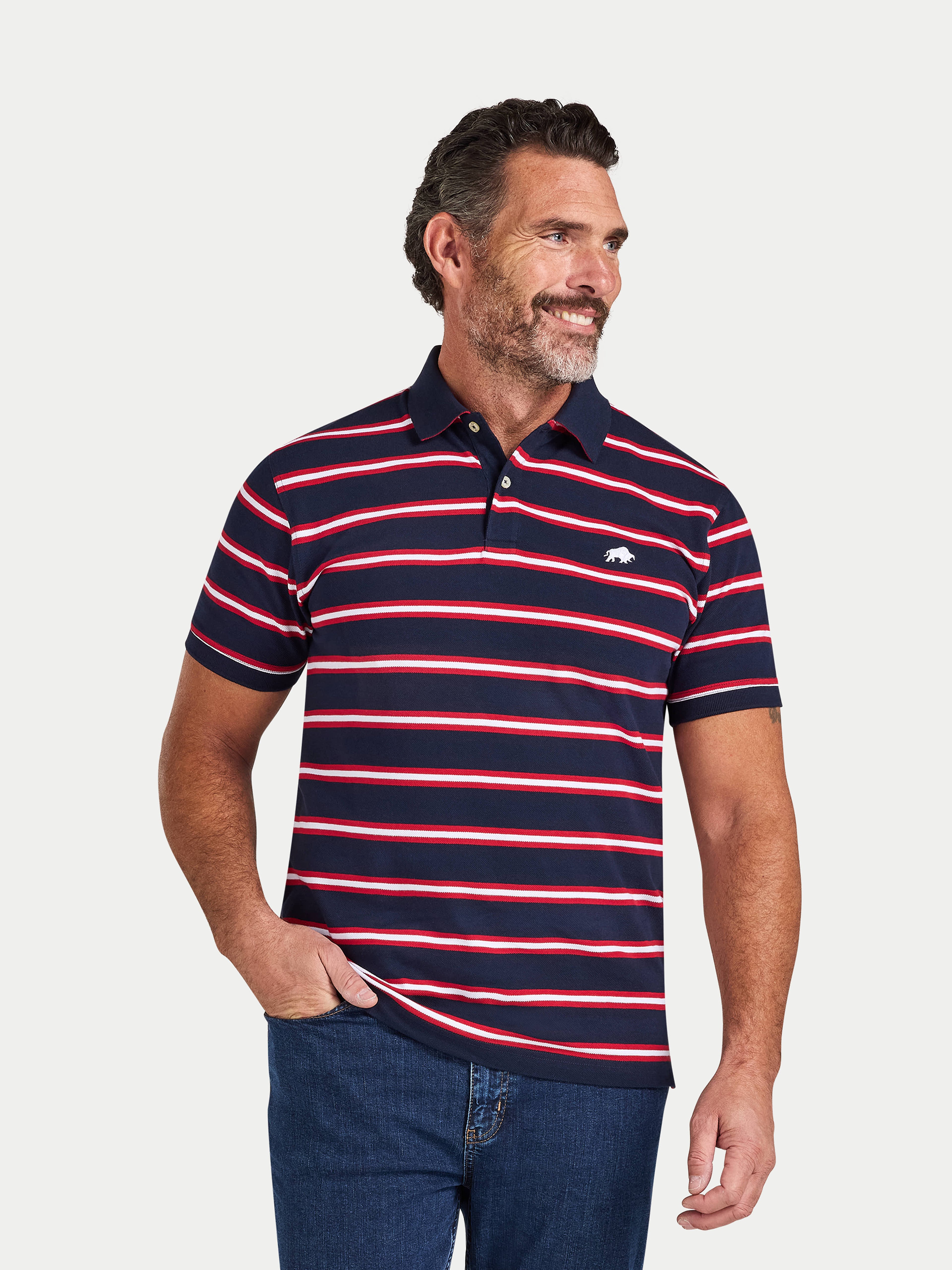 Man wearing a navy and red striped polo shirt on a light gray background