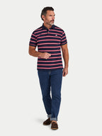 Man wearing a striped polo shirt and jeans on a white background
