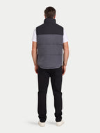 Person wearing a two-tone vest on a white background