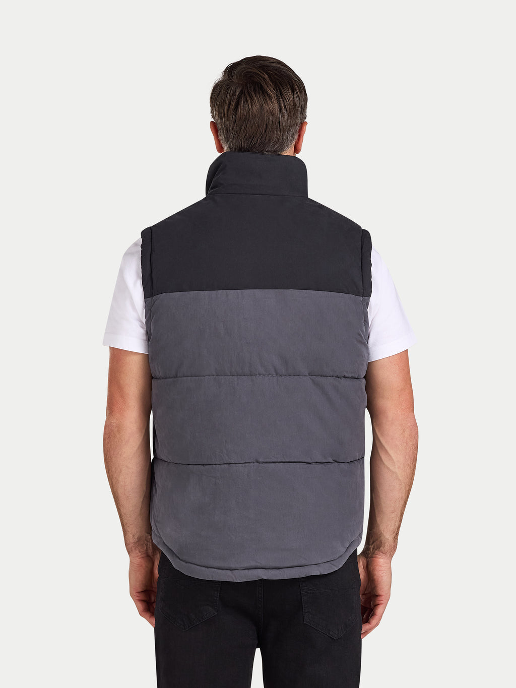 Man wearing a two-tone gray and black vest on a white background