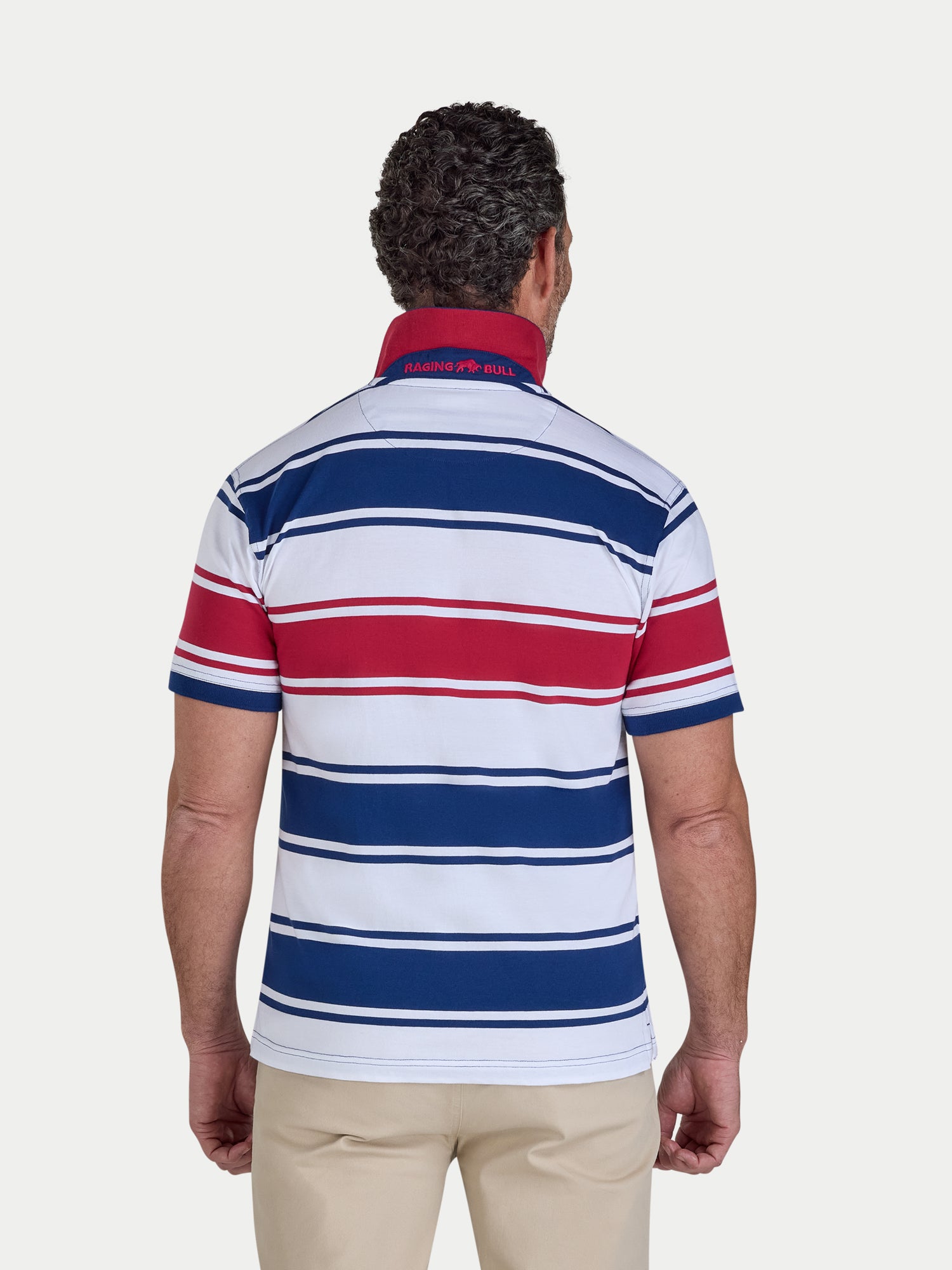 Man wearing a striped polo shirt with visible brand logo on a white background