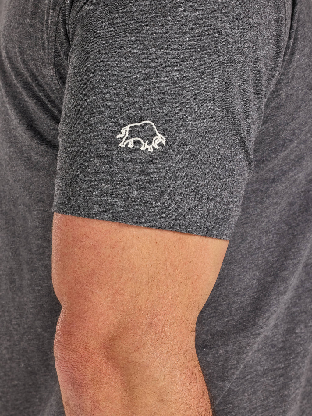Gray t-shirt with a white logo on a person's arm